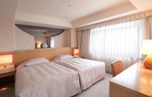 Tempat tidur dalam kamar di Bellino Hotel Ichinoseki