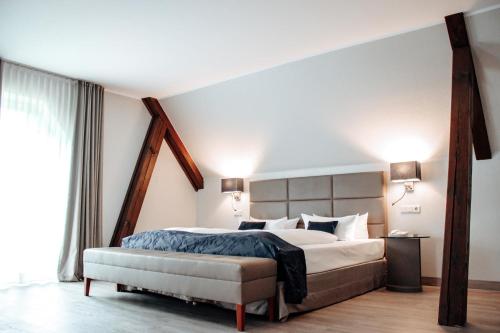 a bedroom with a large bed and a large window at Clostermanns Hof in Niederkassel