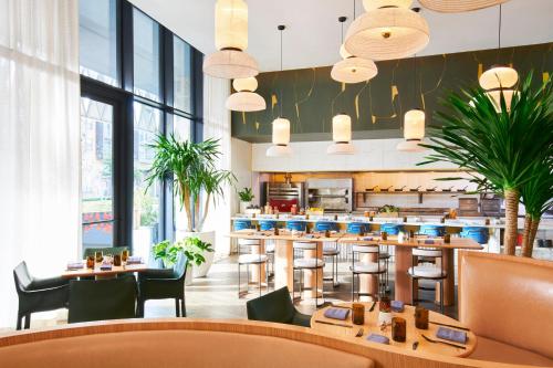 a restaurant with tables and chairs and a bar at Virgin Hotels Dallas in Dallas