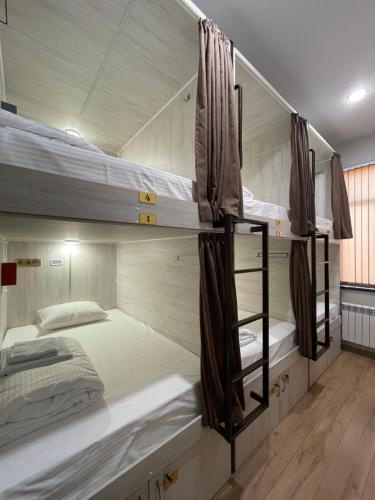 a room with three bunk beds in it at Хостел Baltson in Vladikavkaz