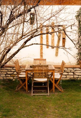 a wooden table and chairs in front of a building at Gulevi Safranbolu in Safranbolu