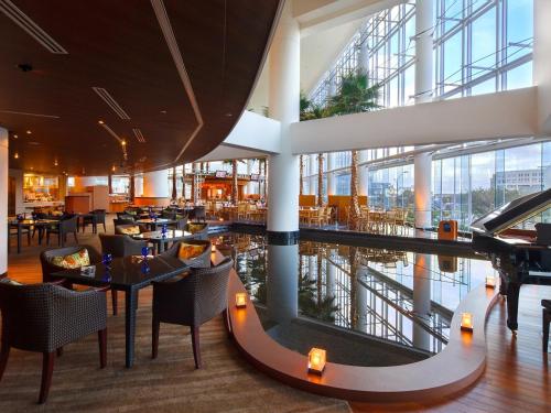 a restaurant with tables and chairs in a building at The Yokohama Bay Hotel Tokyu in Yokohama