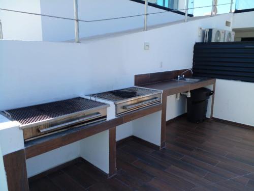 a kitchen with a counter and a sink in it at Departamento en el malecón, Torre Central 102 in Mazatlán
