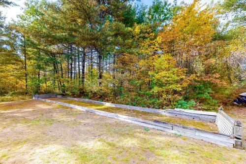 a wooden bench sitting in the middle of a field at Alpen Suite in Ossippee in Ossipee
