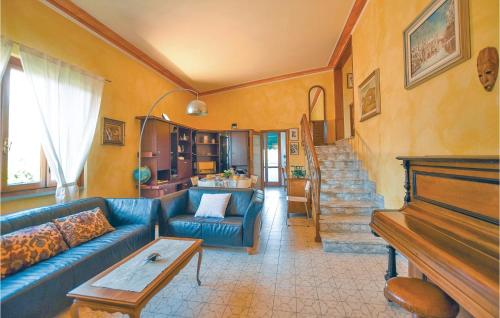 a living room with a blue couch and a piano at Villetta Della Pace in Lido di Camaiore