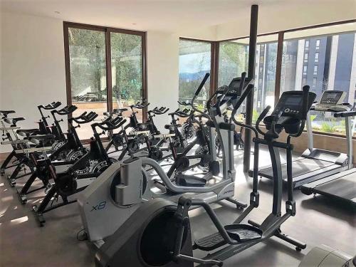 a gym with rows of exercise bikes and treadmills at Parque Pinares Pucón Chile in Pucón