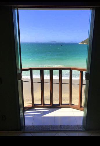 a view of the beach from a window at Orlanova Hotel in Arraial do Cabo
