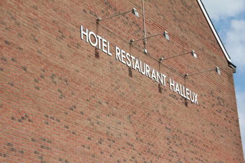 a brick building with a hotel restaurant halley sign on it at Hotel Halleux in Banneux