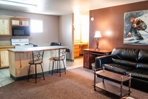 a living room with a bar and a couch at Circle R Motel in East Glacier Park