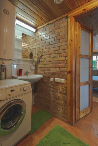 a bathroom with a washing machine and a sink at Namelis prie Magnolijos in Druskininkai