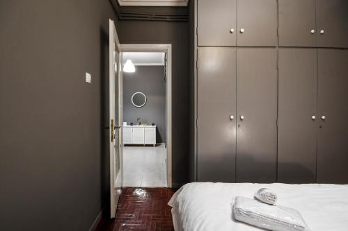 a bedroom with a white bed and a mirror at Thessaloniki Center Apartment in Thessaloniki