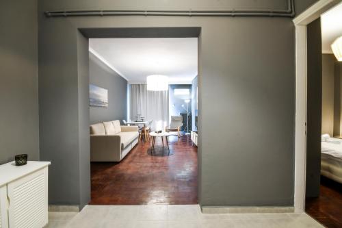 a living room with a couch and a table at Thessaloniki Center Apartment in Thessaloniki