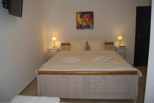 a bedroom with a large white bed with two lamps at Villa Amber in Bad Kissingen