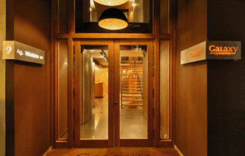 a hallway with a glass door in a building at Galaxy City Center Hotel in Patra
