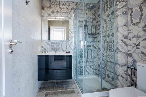 a bathroom with a glass shower and a sink at Palm Mar de LUX A26 in Palm-mar