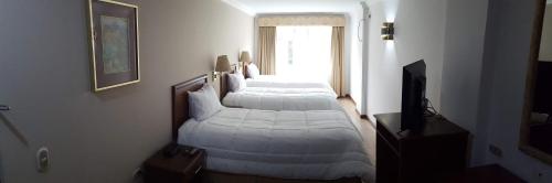 Ένα ή περισσότερα κρεβάτια σε δωμάτιο στο Hotel El Conquistador