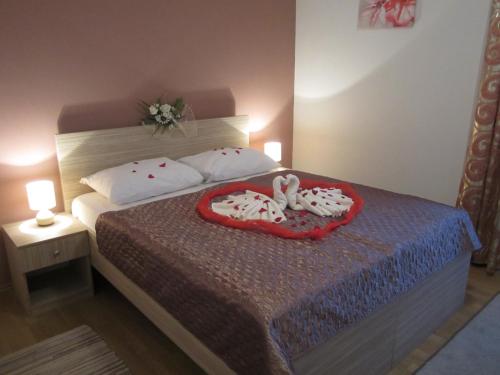 a bedroom with a bed with two stuffed animals on it at Hotel Malta in Mostar