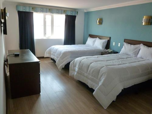 Ένα ή περισσότερα κρεβάτια σε δωμάτιο στο Hotel El Conquistador