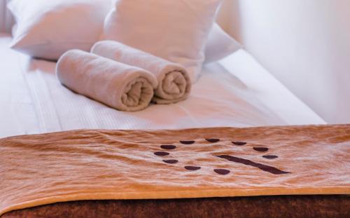 a person laying on a bed with a rug with a dog on it at Boutique Hostel in Łódź