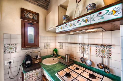 a kitchen with a stove and a sink in it at Atlantis Inn Castelgandolfo in Castel Gandolfo