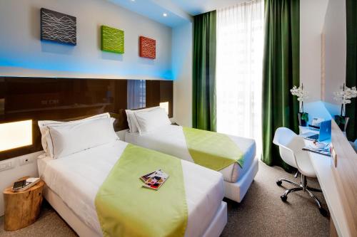 Postel nebo postele na pokoji v ubytování Hotel degli Arcimboldi