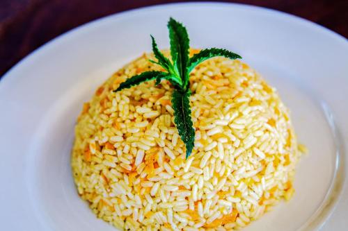 a white plate of rice with a pineapple on it at Livikon by the Sea in Khóra Sfakíon