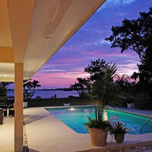 a swimming pool with a view of the water at Perfecto's Retreat- LUXURY Cabin in St. Petersburg