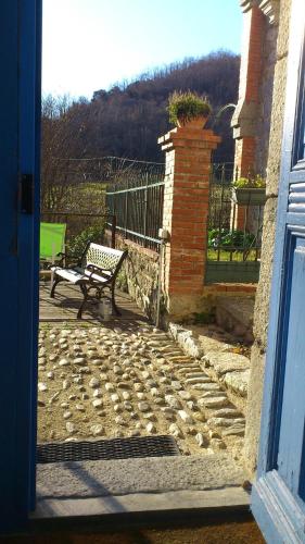 a bench sitting outside of a house with a gate at Mas Manyaques in Le Tech
