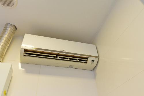 a toaster oven sitting on top of a wall at Pleione Flats in Curitiba