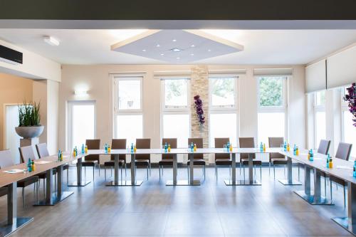 a conference room with a long table and chairs at SleepinRoomz Boutique Hotel in Dortmund