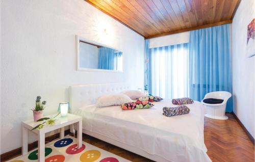 a bedroom with a white bed and a window at Amazing Apartment In Rijeka With House A Panoramic View in Rijeka