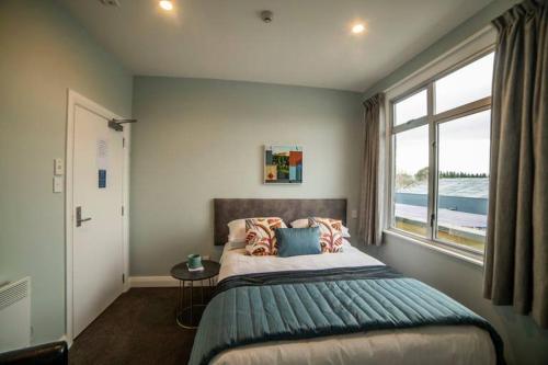 a bedroom with a large bed and a window at The Amberley Hotel in Amberley
