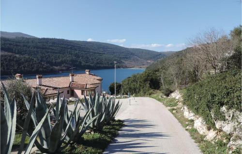 a road leading to a house with a view of a lake at Apartment Labin 58 in Labin