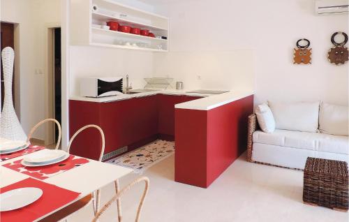 a living room with a red cabinet and a couch at Lovely Apartment In Labin With Wifi in Labin
