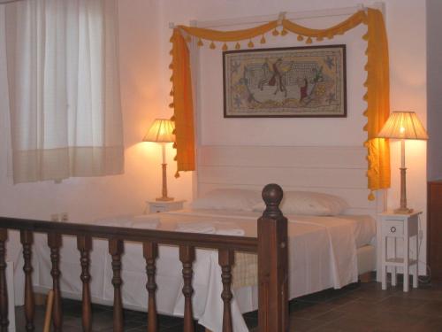 a bedroom with a bed with a picture on the wall at Antigoni in Skiros
