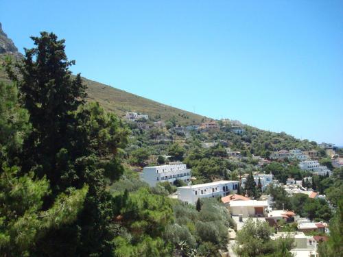 a town on a hill with houses and trees at Pegasus in Masouri
