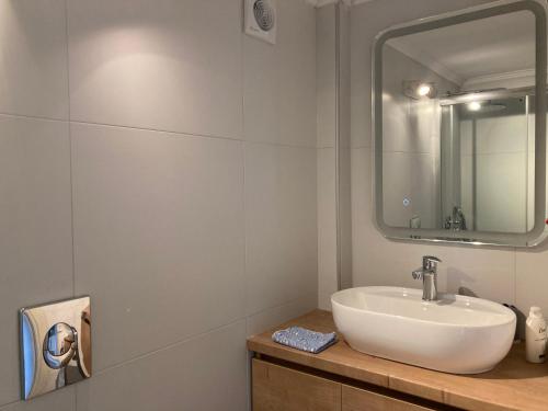 a bathroom with a sink and a mirror at Sofie's Choice Mytilini Ι in Mytilene