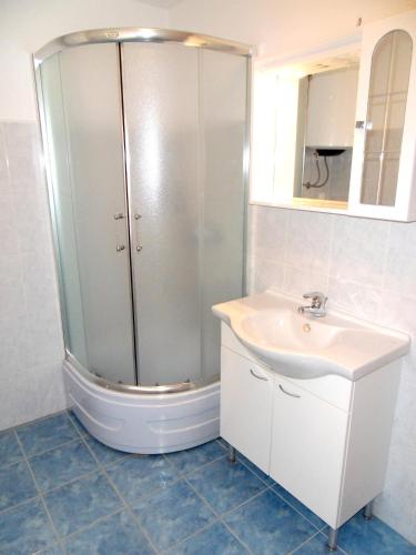 a bathroom with a shower and a sink at Apartments Petricevic 2 in Selce