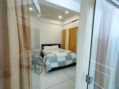 a bedroom with a bed and a glass shower at Raj Holidays Vagamon in Vagamon
