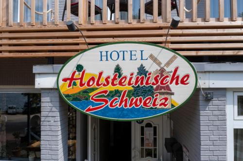 a sign for a hoteliglitzitzisodeoster sign on a building at Hotel Holsteinische Schweiz am Dieksee in Malente