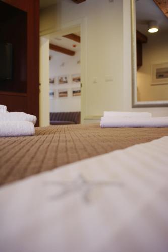 a close up of a bed with a mirror at Guest House Villa Dagmar in Crikvenica
