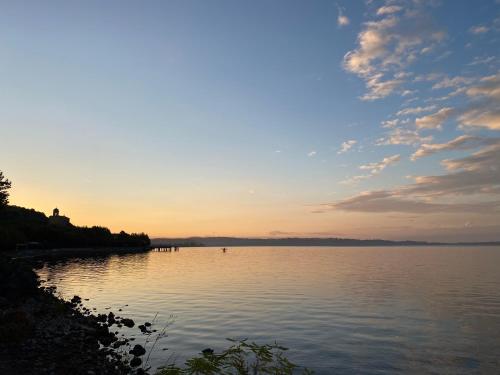 a sunset over a large body of water at Fringiulì House in Trevignano Romano