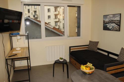 a small room with a bed and a window at Grenoble hyper-centre + WiFi + Netflix in Grenoble