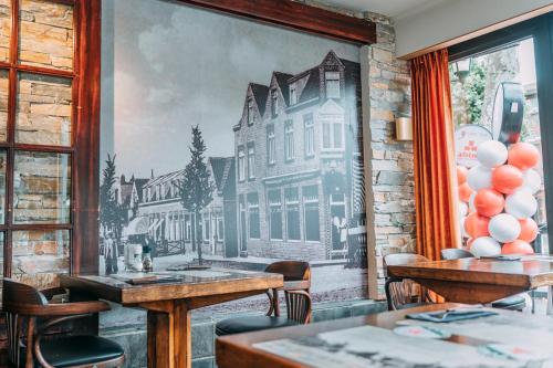 a mural of a building on the wall of a restaurant at Hotel Café Restaurant Abina in Amstelveen