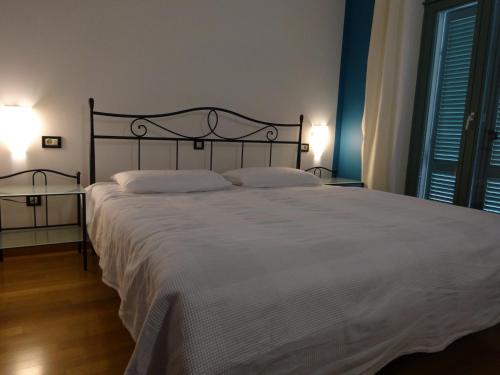 a bedroom with a large white bed with two pillows at Hotel Televrin in Nerezine