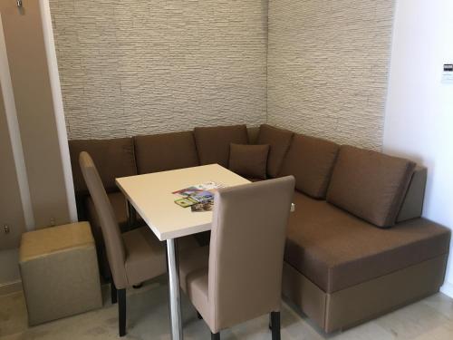 a living room with a couch and a table at Mosoly Szallashely in Szeged