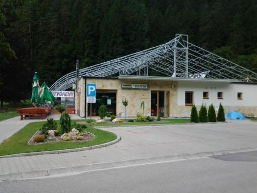a building with a large metal roof on top of it at Apartmán Liptov in Lúčky