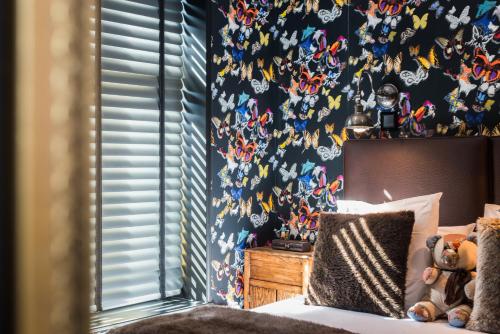 a bedroom with a bed with a spiderman wallpaper at La Goélette, Chambres d'Hôtes in Wimereux
