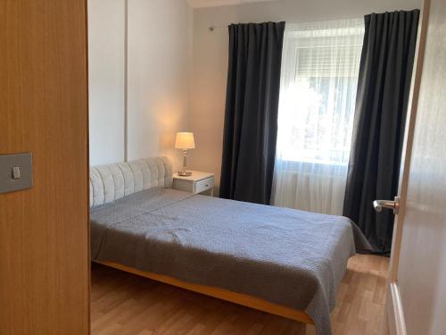 a small bedroom with a bed and a window at Let’s Dream Apartment 68 m2 in Kraków