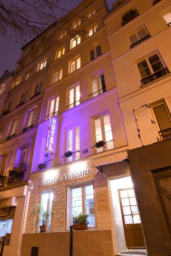 a building with a purple lit up sign on it at Hotel d'Orléans Paris Gare de l'Est in Paris